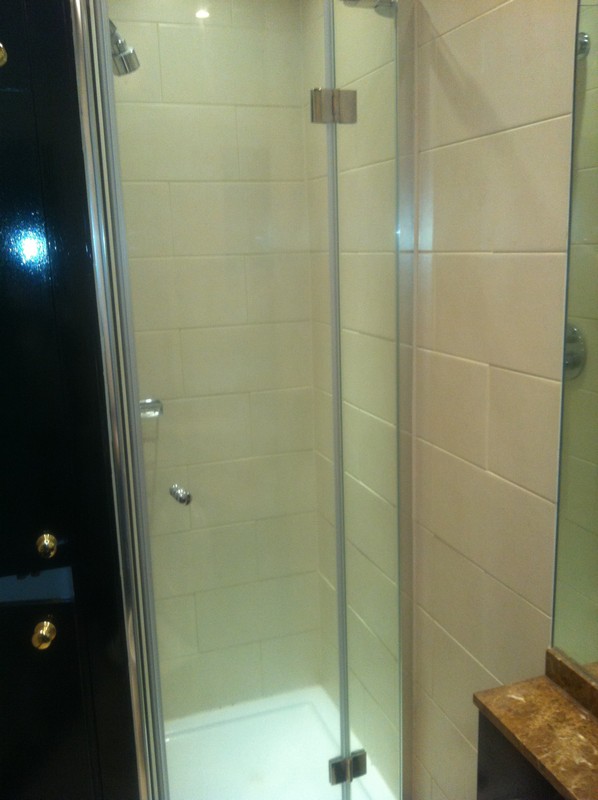 Frameless glass shower enclosure with chrome fittings in Penge