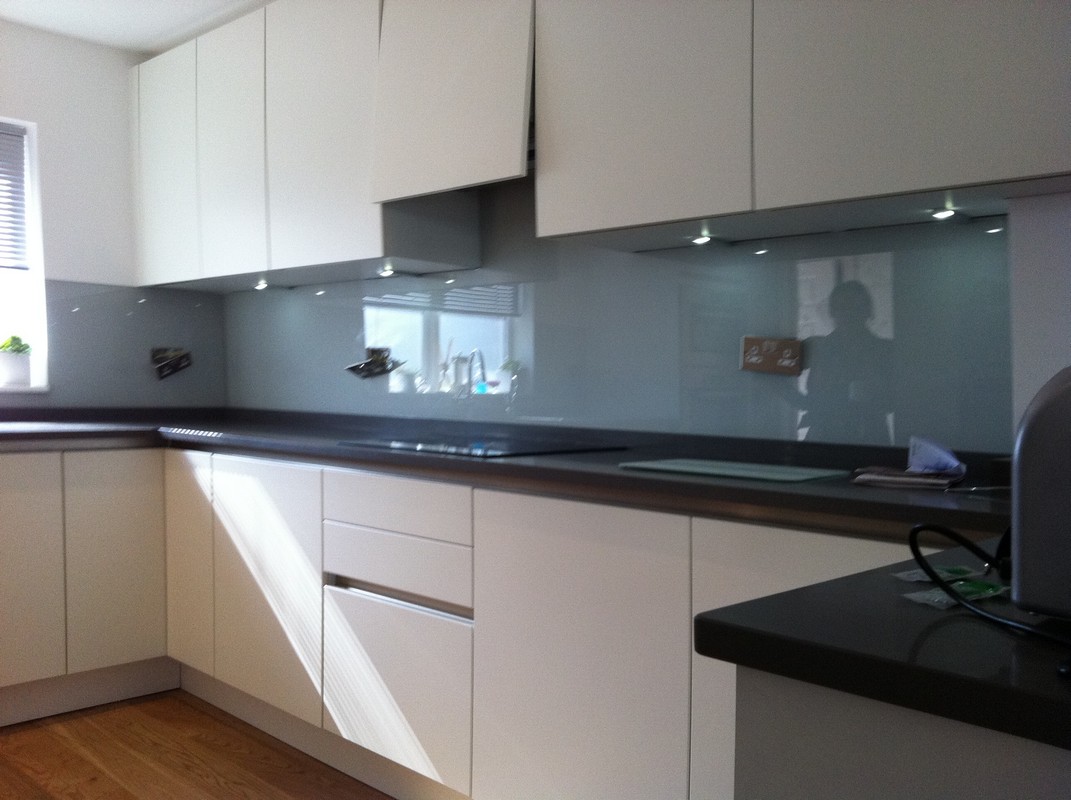 Grey glass kitchen splashback with LED lighting in Penge